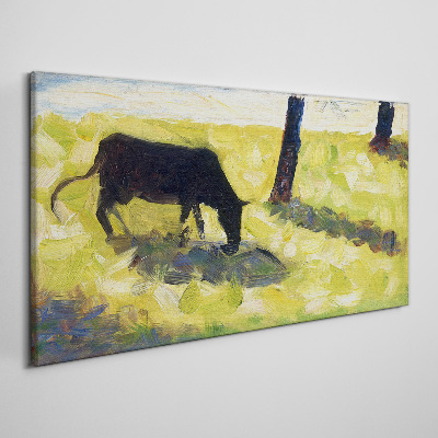 Tablou canvas O vacă care pășește într-un peisaj verde