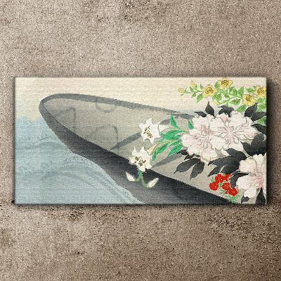 Tablou canvas Barcă cu flori pe apă calmă