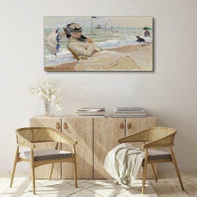 Tablou canvas Femeie pe plajă cu o umbrelă