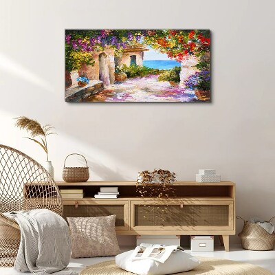 Tablou canvas Aleea cu flori a unui sat de pe litoral